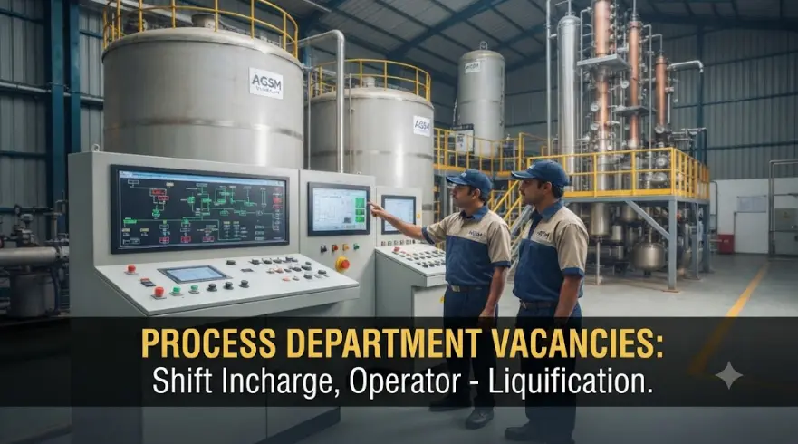 Two male operators in uniform reviewing process parameters on a large multi-screen control console inside the AGSM Liquors ethanol plant control room.